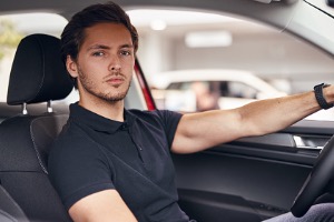 Man with serious face in car 